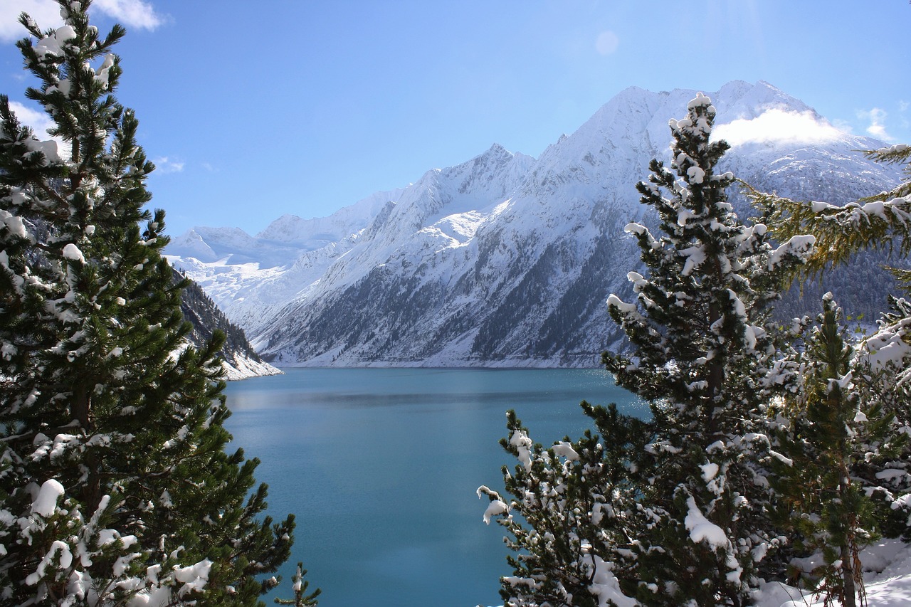 Snow on trees around lake in Austrian Alps